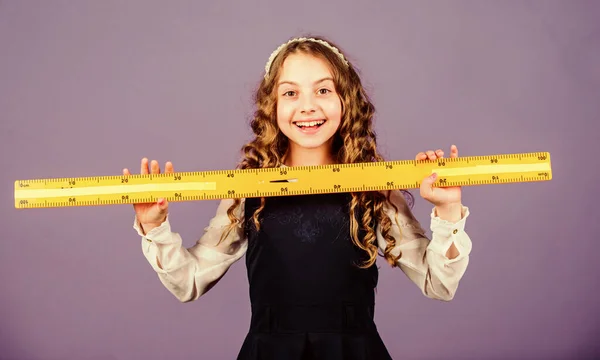 Geometry school subject. Education and school concept. Smart and clever concept. Sizing and measuring. School student study geometry. Kid school uniform hold ruler. Pupil cute girl with big ruler — Stock Photo, Image