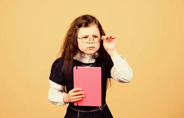 Serious small girl wants to be teacher. notebook for diary notes. study lesson. knowledge and education. Back to school. hometwork. small girl with paper folder. School curriculum — Stock Photo, Image