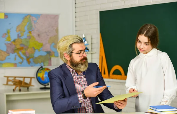 Bearded man teacher in classroom. Teacher checking right answer. Track student progress. Teaching materials. Who is absent today. Teaching concept. Private lesson. Homeschooling. Back to school