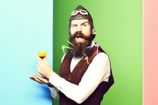 funny handsome bearded pilot on studio background