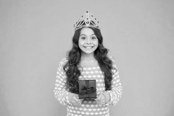 Portrait of cute smiling little girl with gift box. kid in princess crown. happy birthday daughter. Birthday Princess. Kid silver crown symbol of glory. portrait of pride. happy childrens day