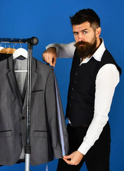 Man met baard bij kledingrek. Mode en bedrijfsstijl — Stockfoto