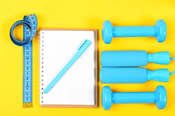 Dumbbell tools for weight loss. Sport instruments and measure tape — Stock Photo, Image