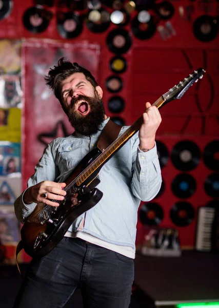 Rock singer concept. Musician with beard play electric guitar instrument. — Stock Photo, Image