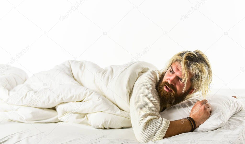 Interrupted sleep. Sleep concept. Regularly sleeping more than suggested amount may increase risk of obesity headache back pain and heart disease. Nap and sleep. Man sleepy face lies on pillow