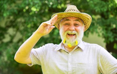 Used to be cowboy. Guy bearded cowboy in nature. Grandpa rustic style clothes and cowboy hat. Cheerful cowboy. Owner of family ranch. Man unshaven smiling face. Farm concept. Living in countryside clipart
