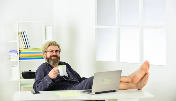 Business coach. man is working at home during coronavirus pandemic. man sit on comfortable chair using laptop. online in social media. working barefoot at home office. social distancing concept — Stock Photo, Image