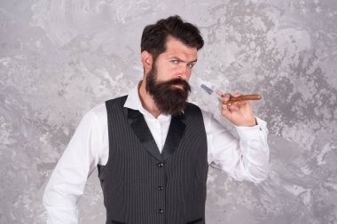 Sakalını mükemmelleştiriyor. Erkekler için kuaför salonu. Retro ve klasik moda. Saç ve sakal bakımı. Kendine güvenen ve yakışıklı vahşi bir adam. Erkek sabah bakımı. Kişisel yüz bakımı. Tıraş eden adamın usturası vardır.