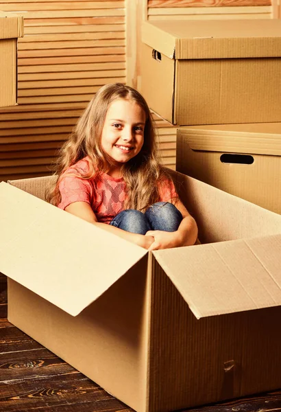 Ideal Place. repair of room. new apartment. purchase of new habitation. Cardboard boxes - moving to new house. happy child cardboard box. happy little girl with bear toy