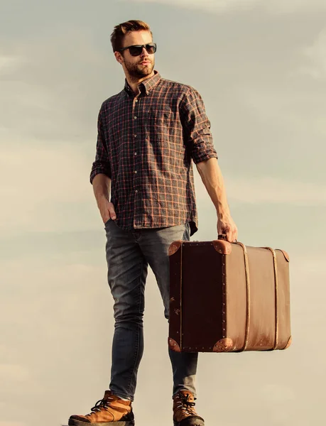 Viaje con equipaje. Blogger de viajes. Un hombre cargando sus cosas en equipaje. Tiempo de vacaciones. Agencia de viajes. Viaje de negocios. Un viajero guapo. Tipo al aire libre con maleta vintage. Concepto de equipaje —  Fotos de Stock