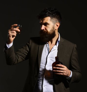 İçki içen sakallı şarap garsonu. Adam cama bakıyor.