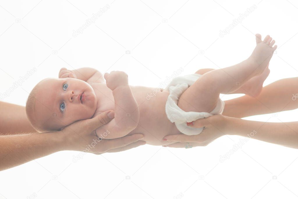 Love, innocence and childhood concept. Newborn kid with angelic face lies on parent hands.