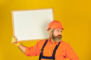 Plan onarımı işe yarıyor. Projeyi gösteren mimar. Profesyonel tamirci. Görsel taslak. Sorun çözme konsepti. Sakallı adam tamirci. Tamirci, beyaz tahta kopyalama alanını tut. Yakışıklı tamirci.