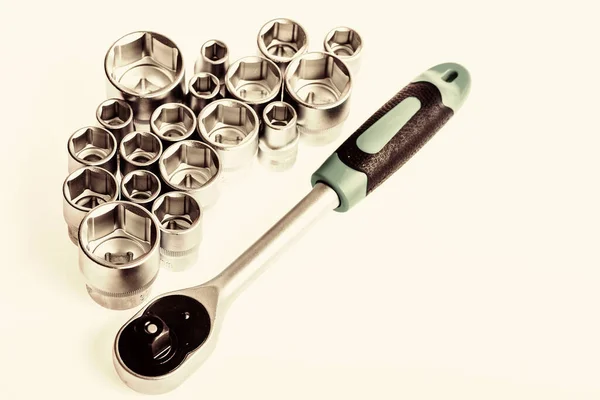 Tools for repair and construction. Main advantage of heads used to unwind or tighten nuts and bolts hard to reach places. Home improvement tools concept. Shop for ratchets and sockets in hand tools — Stock Photo, Image