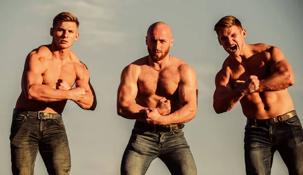 Strong men are sexy. showing abs and biceps. full of energy. Inspiring better health. three muscular men sky. athletic bodybuilders. sport concept. Sexy men with muscular body. Brutal macho