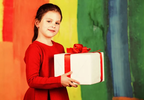 Give away. Merry Christmas and happy holidays. Winter holidays. Little girl hold gift box. Kid hold present box colorful background. Xmas gift shopping. Family tradition. Beautiful gift package
