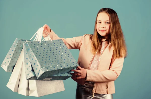 Feliz niña. Niña con regalos. Ahorro de compra vacaciones. Moda infantil. asistente de tienda con paquete. Ventas y descuentos. Niña pequeña con bolsas de compras. Bolsas pesadas. Fácil y rápido —  Fotos de Stock