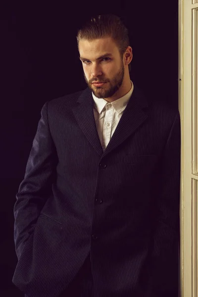 business man in black suit on black background