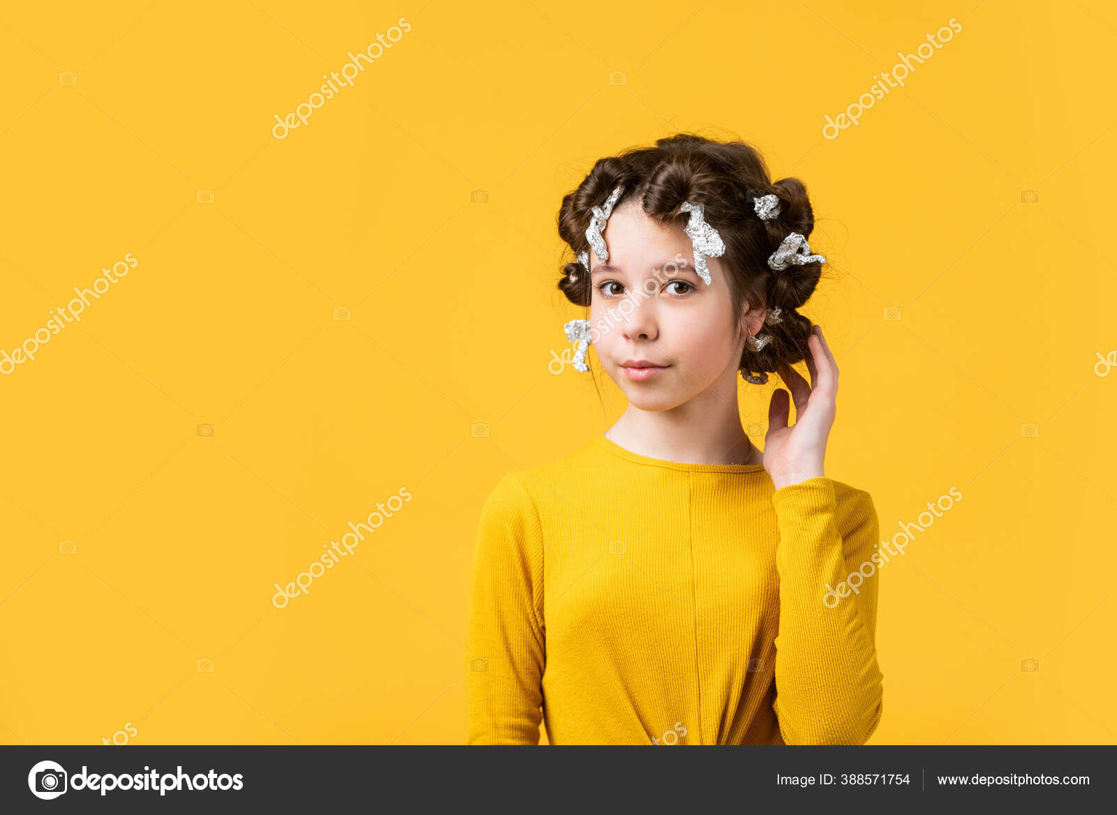 Pose with tin foil hair curlers. happy girl in hair curlers playing  hairdresser salon. Easy tips making hairstyle for kids. hairdressing tools  and hair accessories. kid with happy face. copy space Stock