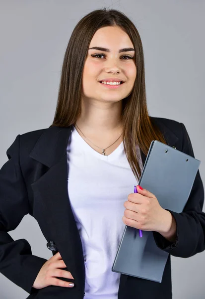 elegant smiling woman in jacket. trendy office worker. formal casual fashion style. stylish woman hold office folder. girl follow dress code. confident businesswoman with documents