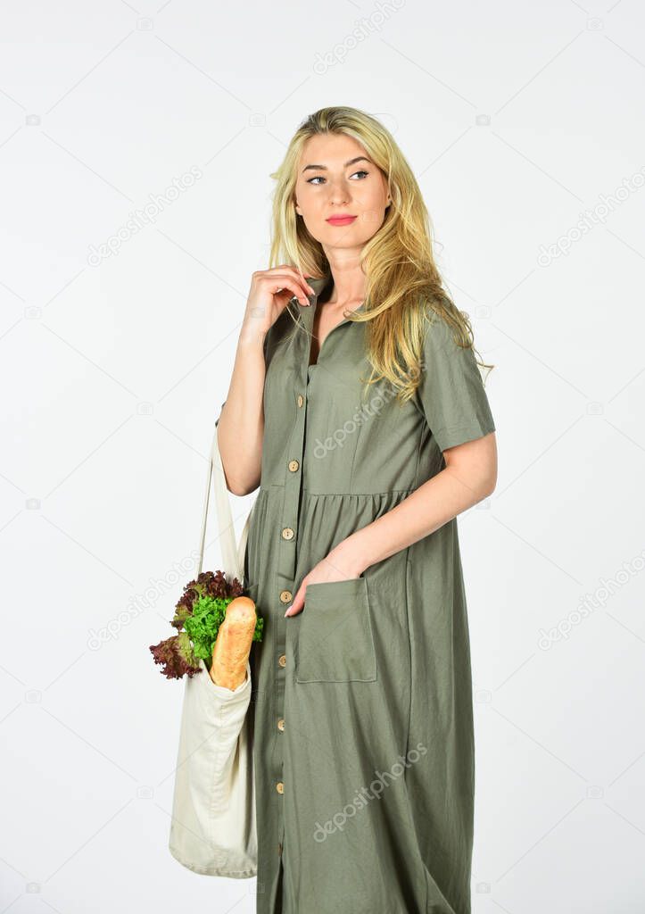 Reusable bag. Eco lifestyle. Eco shopping. Conscious consumption. Eco trend. Grocery store. Zero waste. Girl in dress carry shopper. Woman holding string shopping bag with fruits. Reusable eco bag