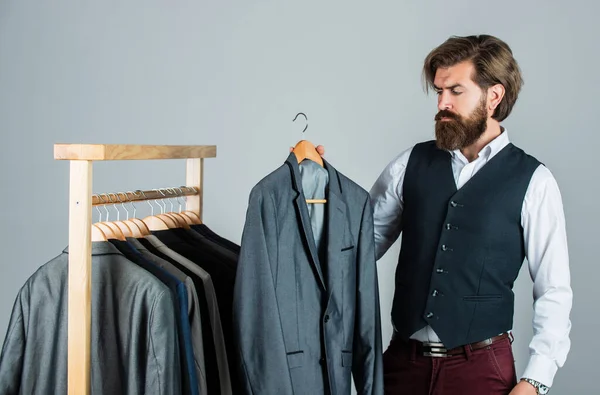 Fits perfect. Man clothing in boutique. Man with suit. tailor in his workshop. Handsome bearded fashion man in classical costume suit. Man in custom tailored suit presenting expensive tailored tuxedo — Stock Photo, Image