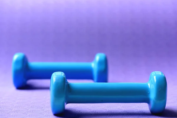 Barbells feitos de plástico, de perto. halteres em azul ciano — Fotografia de Stock