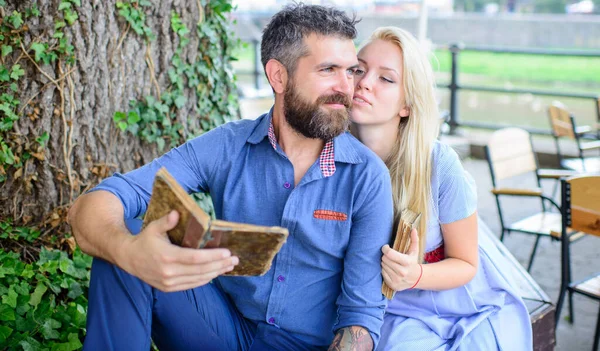 Romantic couple holds old books with poems.