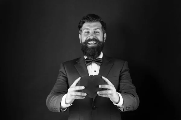 Best wishes from sincere heart. Businessman in bow tie. Heart symbol aesthetics. Valentines day holiday. Love and relations. Wedding day. Bearded man groom in formal suit. Health care. Heart in hands