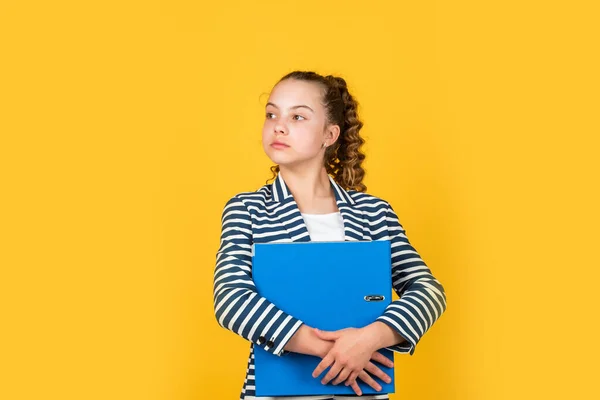 Thinking about problems. kid with curly hair wear jacket. work with documents. schoolgirl has paperwork homework. back to school. small girl with office folder. little businesswoman. happy childhood — Stock Photo, Image