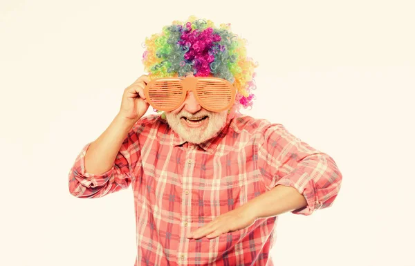 Having fun. Funny lifestyle. Fun and entertainment. Comic grandfather concept. Nice joke. Grandpa always fun. Elderly clown. Man senior bearded cheerful person wear colorful wig and sunglasses — Stock Photo, Image