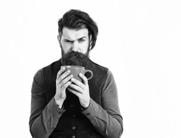 Szakállas férfi kezében csésze kávé, tea komoly arccal — Stock Fotó