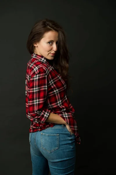 Simple casual clothes. Feeling comfortable. She prefers casual style. Country style. Woman checkered shirt. Attractive confident girl black background. Sexy people. Casual fashion. Fashionable outfit