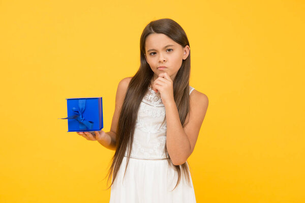What if. Thoughtful child. Stop consumerism. Conscious purchase. Shopping concept. Portrait girl. Birthday gift. Child happy hold gift box. Kid girl delighted gift. Shopping and discount. Thinking
