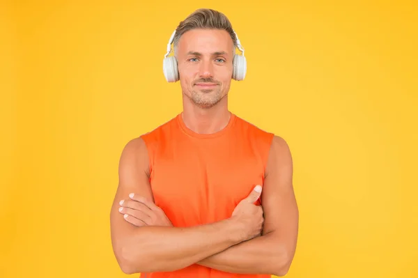 Healthy sportsman or athlete. Sport and fitness. Music for fitness. Sportsman listen music. Sportsman training. Regular workout. Mature coach. Strong sportsman wear headphones and fitness uniform — Stock Photo, Image