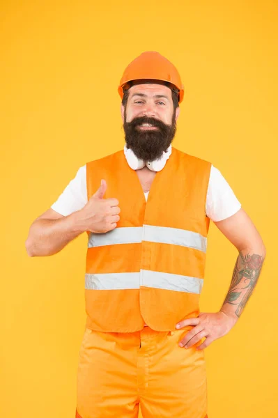 Creative solutions. Man protective hard hat and uniform. Strong handsome builder. Indoors works. Dangerous works. Worker brutal bearded builder confident looking camera. Protective equipment concept