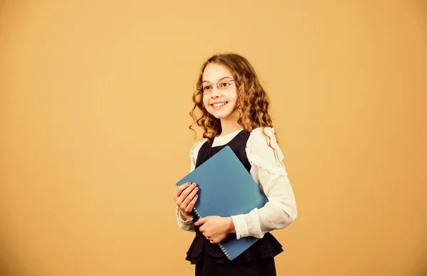 Girl hold textbook folder test. Preparing to exams in library. Small child formal wear. Formal education and homeschooling. Check knowledge. School exam concept. Prepare for exam. Final exam coming