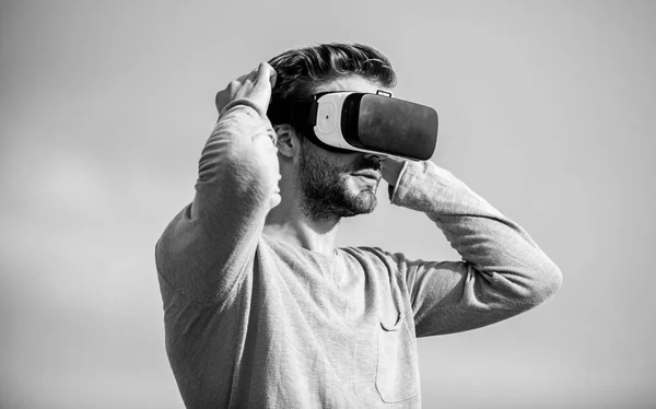 Digital future and innovation. Cyber space. Virtual reality. Handsome man with wireless VR glasses headset. Game online. Virtual reality goggles. Augmented reality. Gamer concept. Modern technology