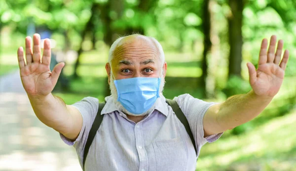 Mask protecting from virus. Older people highest risk covid-19. Easing of lockdown restrictions. Wear mask. Quarantine extended. Pandemic concept. Limit risk infection spreading. Senior man face mask