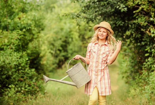 My job is my passion. spring country side village. summer season. small girl with watering can. earth day. environment ecology. nature protection. girl farmer care plants. farming and agriculture — Stock Photo, Image