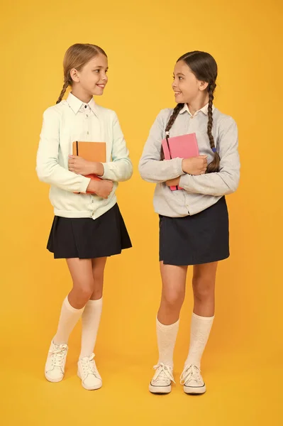 Knowledge day. Schoolgirls best friends excellent pupils. Secondary school. Schoolgirls tidy appearance school uniform. School friendship. School day fun cheerful moments. Kids cute students