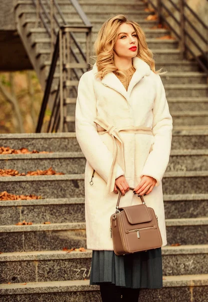 So nice. european winter. girl warm coat stairs background. faux fur coat fashion. stylish business lady leather bag. glamour girl look luxuriously. sexy blong woman red lipstick. autumn season — Stock Photo, Image