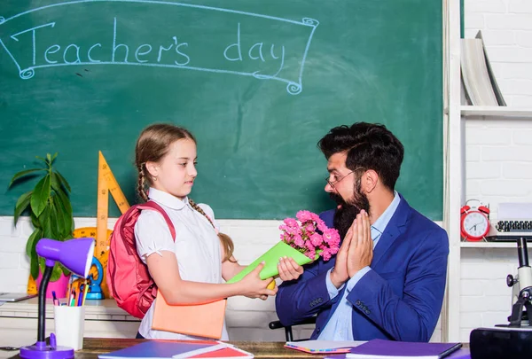 Aluna agradecida. De volta à escola. Felicidades. Menina aluno adorável com mochila dando professor de flores de buquê. Parabéns pelo dia do conhecimento. Saudações para o pedagogo da escola. Férias escolares — Fotografia de Stock