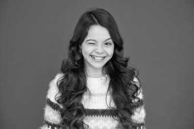 Göz kırpan surat. Doğal bukleler. Çocuk şirin, sevimli, kıvırcık saçlı. Uzun saçlı, kendine güvenen bir çocuk. Kıvırcık saçlı kız kendine güveniyor. Çocuk psikolojisi ve gelişimi. Kendinden emin duruş