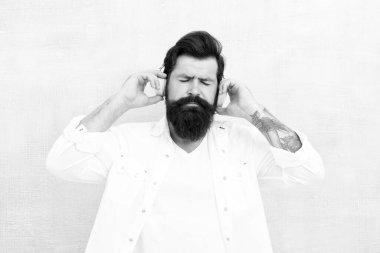 Rahatlatıcı. Müzikle yürümek. Yeni teknoloji. Sakallı adam kulaklık takıyor. Vahşi hippi müzik dinler. Akışına bırak. ilham verici kulaklık kullanıcısı. En sevdiği şarkı. saf ses