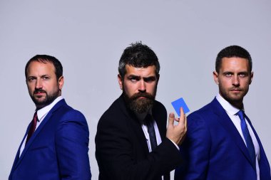 Yöneticiler ortaklığı temsil ediyor. Şirket liderinin elinde boş mavi kartvizit var.