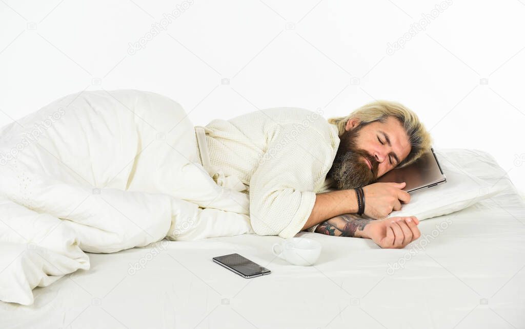 Blue Light Effect. Man with sleepy face lies on pillow with laptop. Deep sleep concept. Man with beard and mustache sleeping. Healthy sleeping. Social networks dependence. Inseparable from gadgets