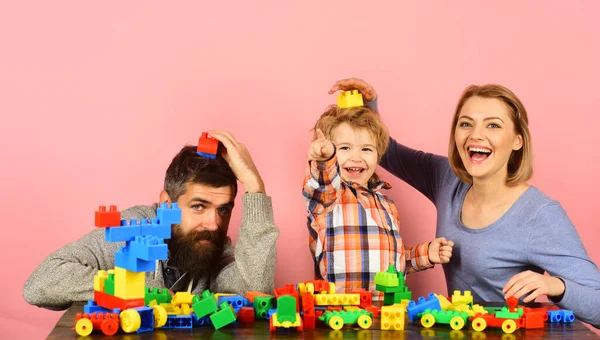 Parenthood and game concept. Man with beard, woman and boy