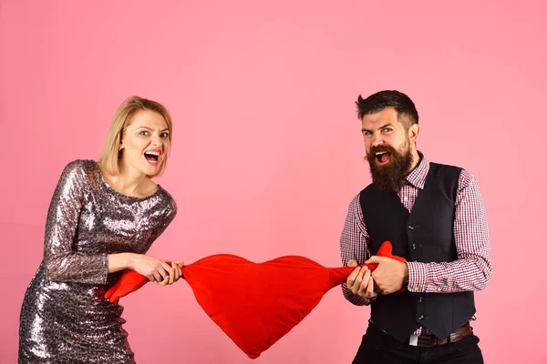 Couple in love tears big heart on pink background