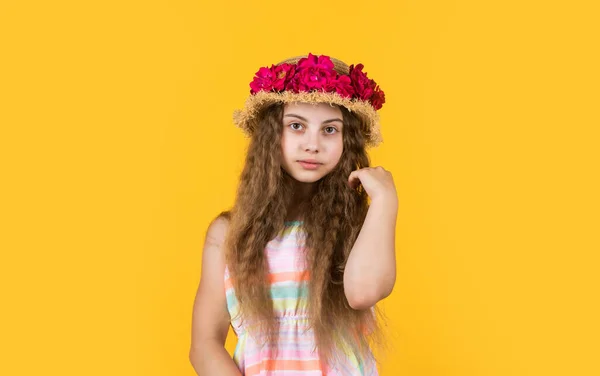 Confidence in mind. happy womens day. Portrait of small kid with flowers. love and beauty. stunning girl with flowers of roses in hat. happy child in straw hat. Hairstyle of nature. mothers day